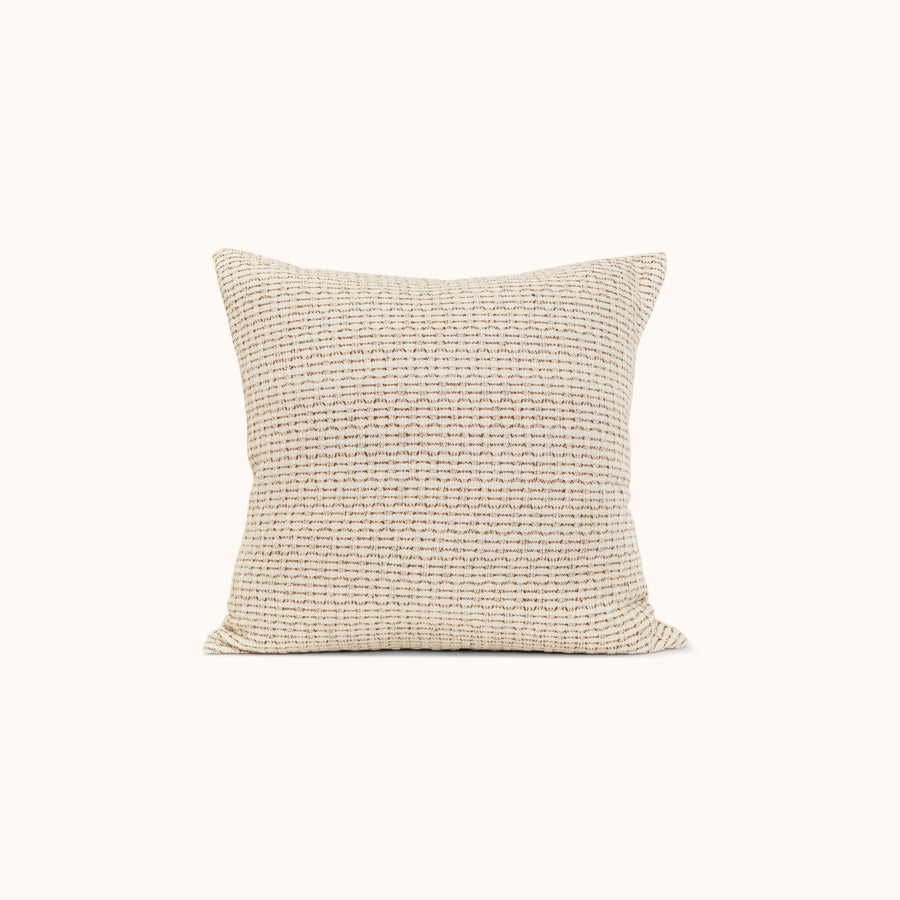 A throw pillow with a beige and brown hazelnut stripe texture in a jacquard weave.