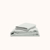 A folded organic matte sateen sheet set in Mist displayed neatly against a white background.