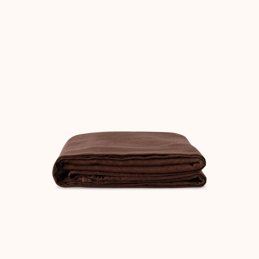 Brown flat or top sheet folded neatly against a white background 