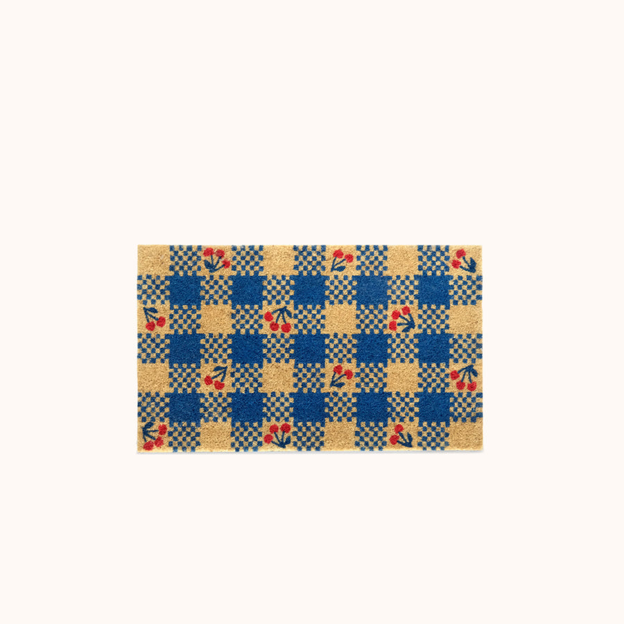 Checkered doormat with cherry patterns on a white background