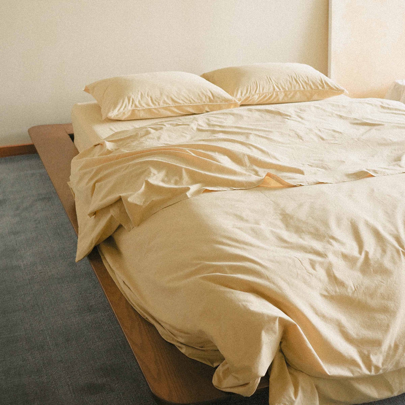 Yellow duvet cover on a bed in a minimalistic room