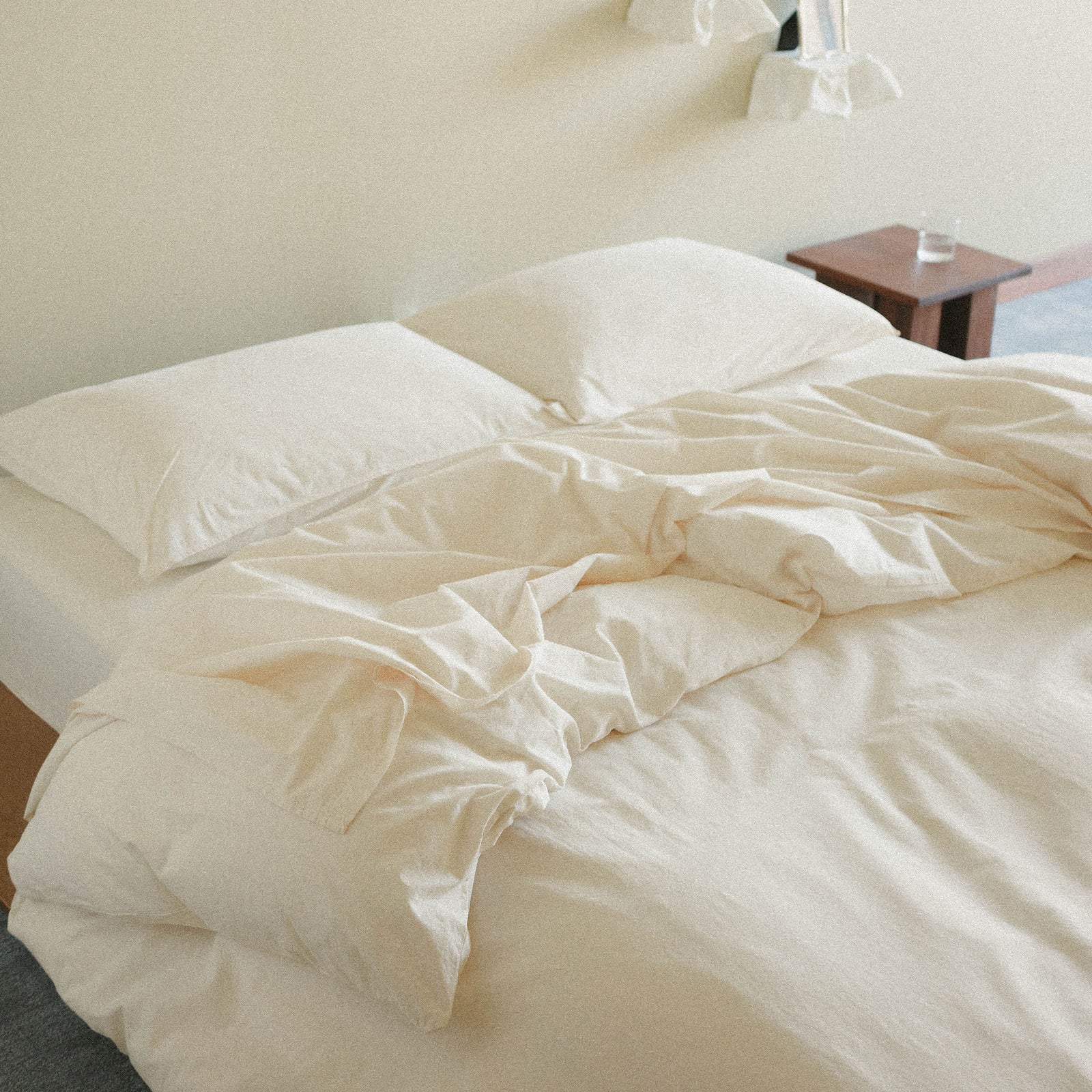 Cream duvet cover and pillows in a bedroom setting