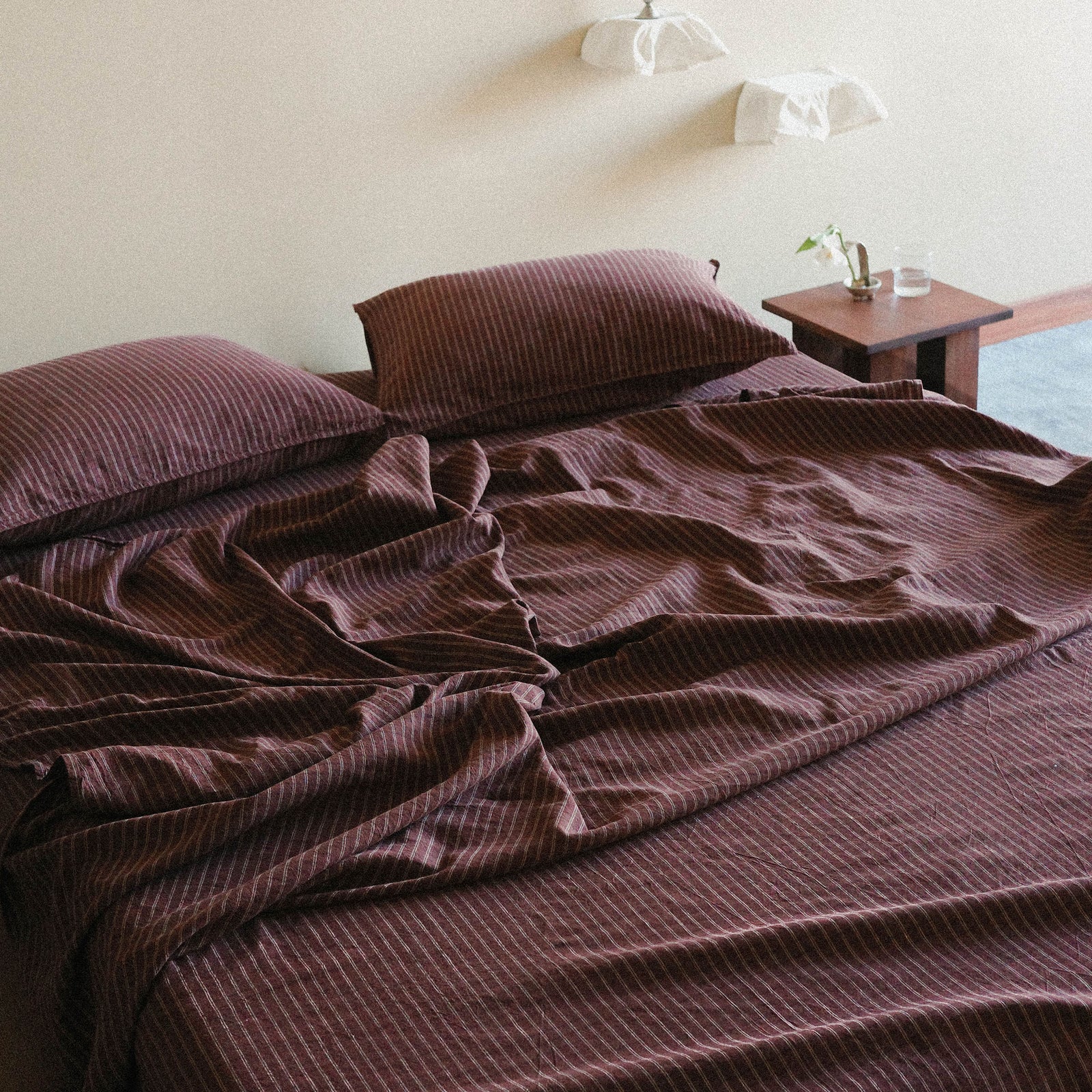 Brown Striped bedspread on a bed in a bedroom setting.