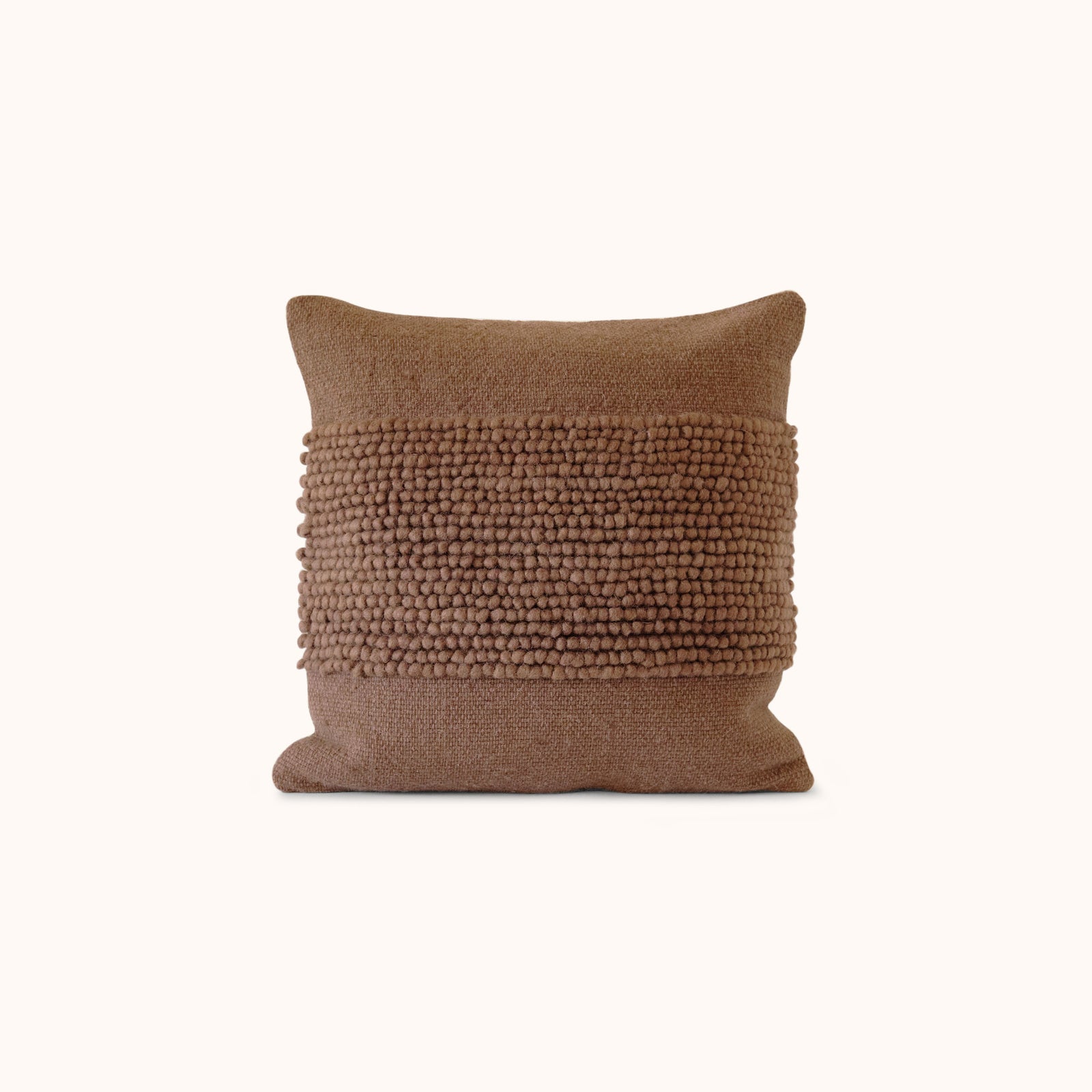 A solid brown throw pillow with a textured center design.