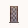 A long rectangular woven mat with a brown and light blue checkerboard pattern, displayed flat against a solid off-white background.