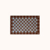 A rectangular mat with a brown and light blue checkerboard pattern, displayed flat against a solid off-white background.
