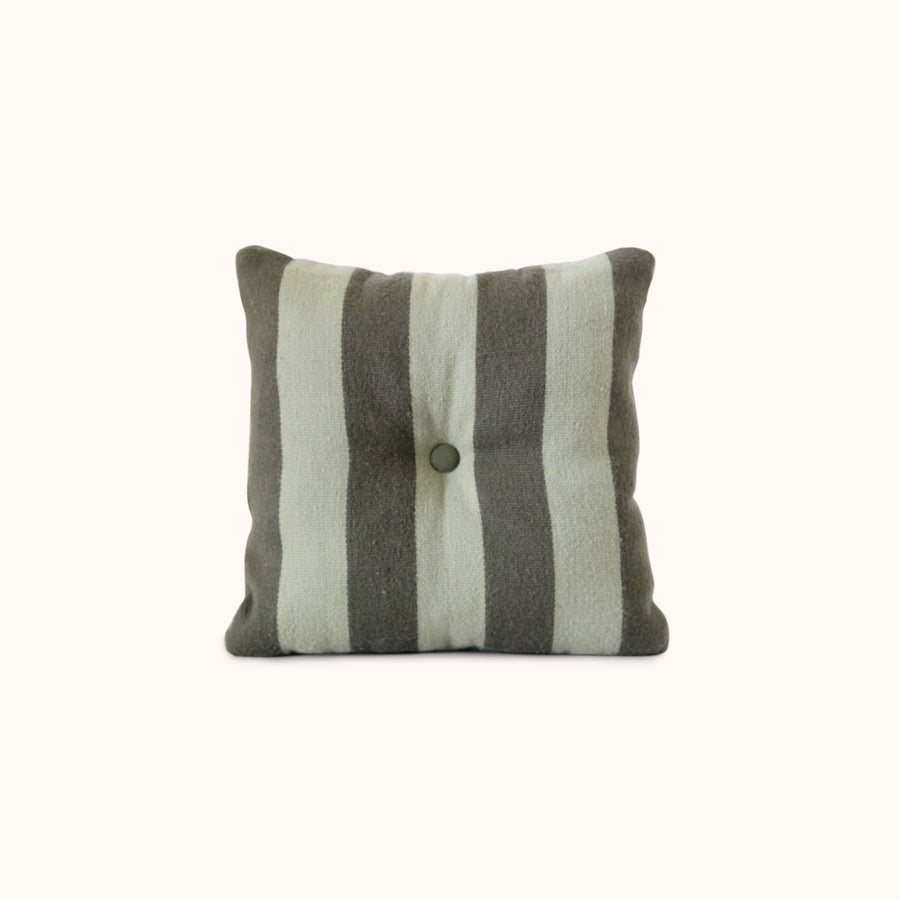Striped green pillow with a button on a white background