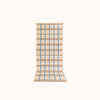 A rectangular, runner with a geometric checkered pattern in blue and tan on a natural beige background, designed for use as a kitchen or bath mat.