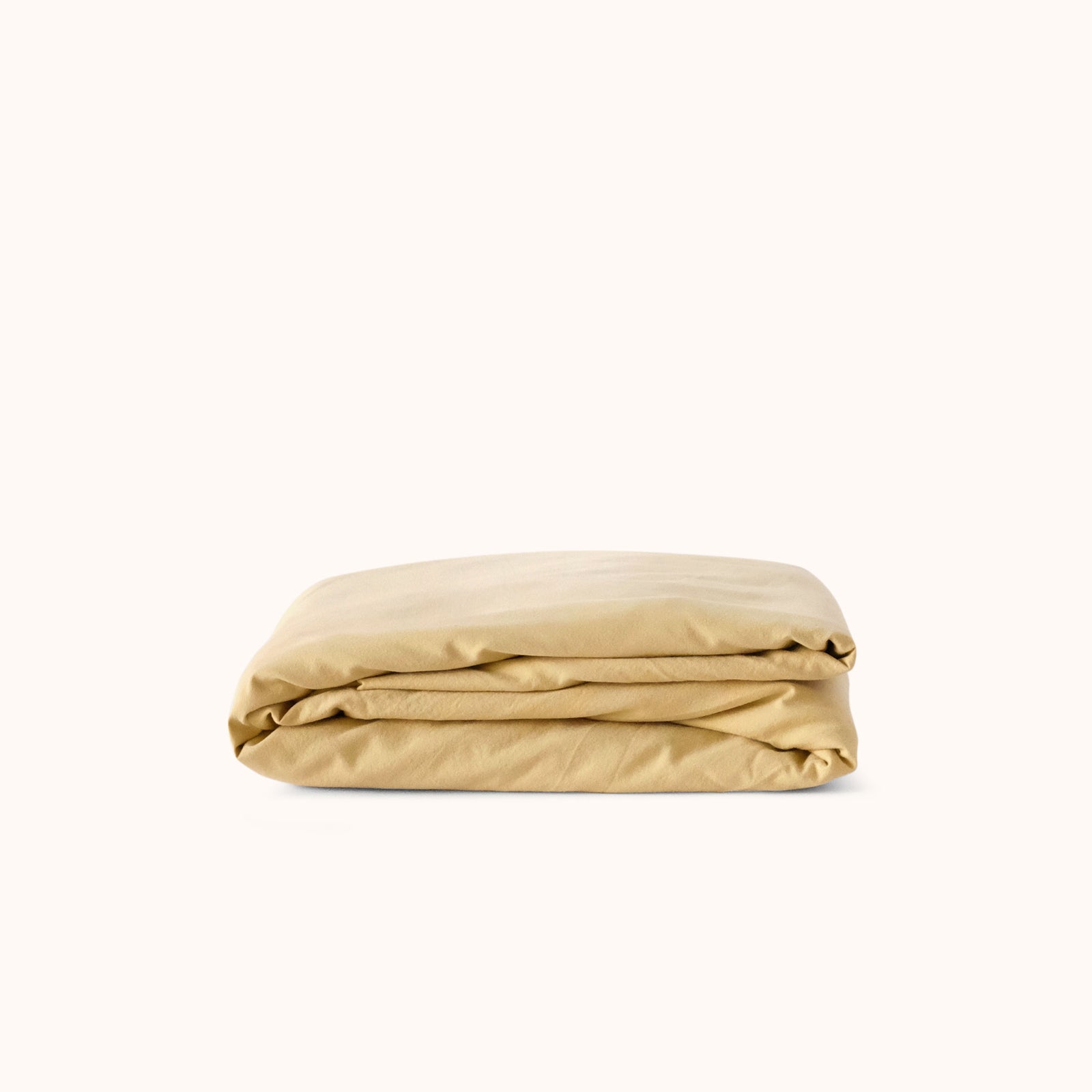 yellow fitted sheet folded on a white background