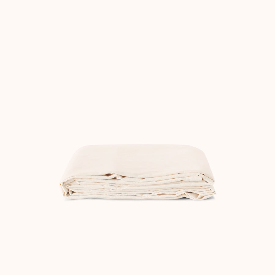 Folded cream flat sheet on a white background