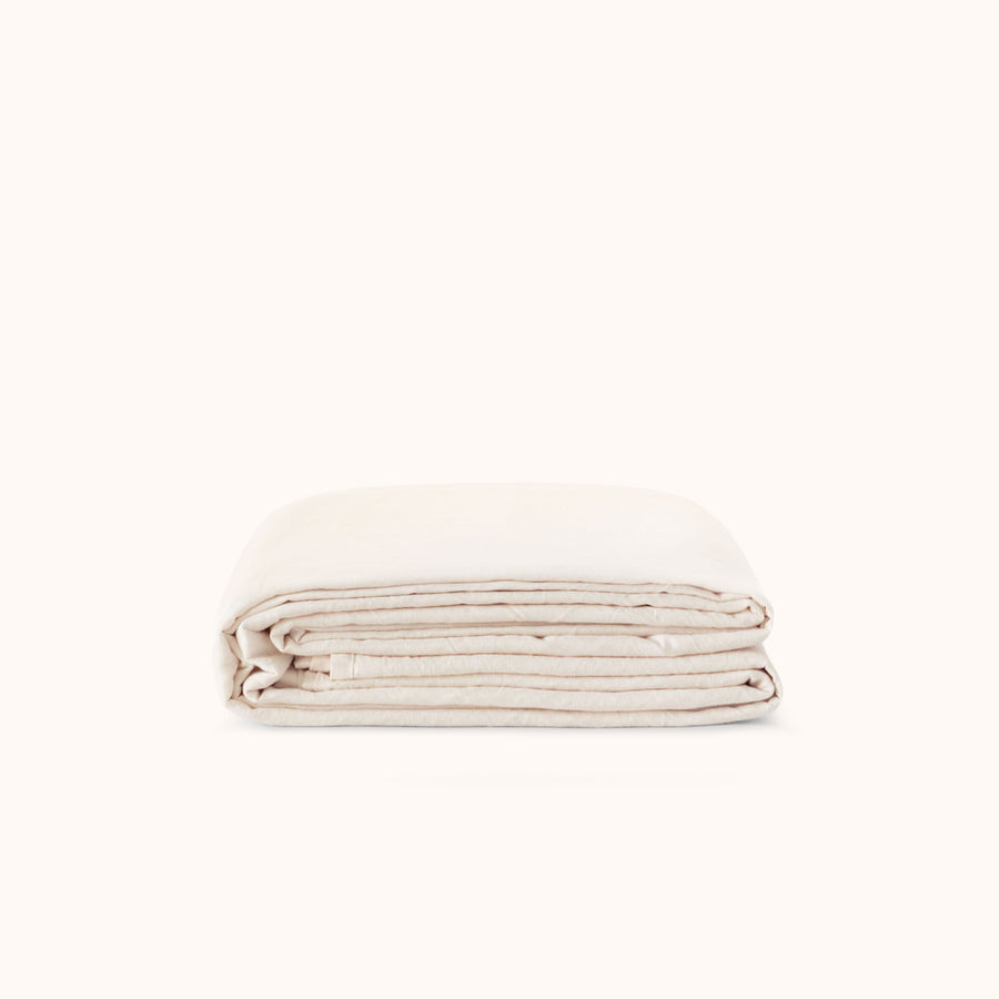 Folded flat or top sheet in a cream color against a white background