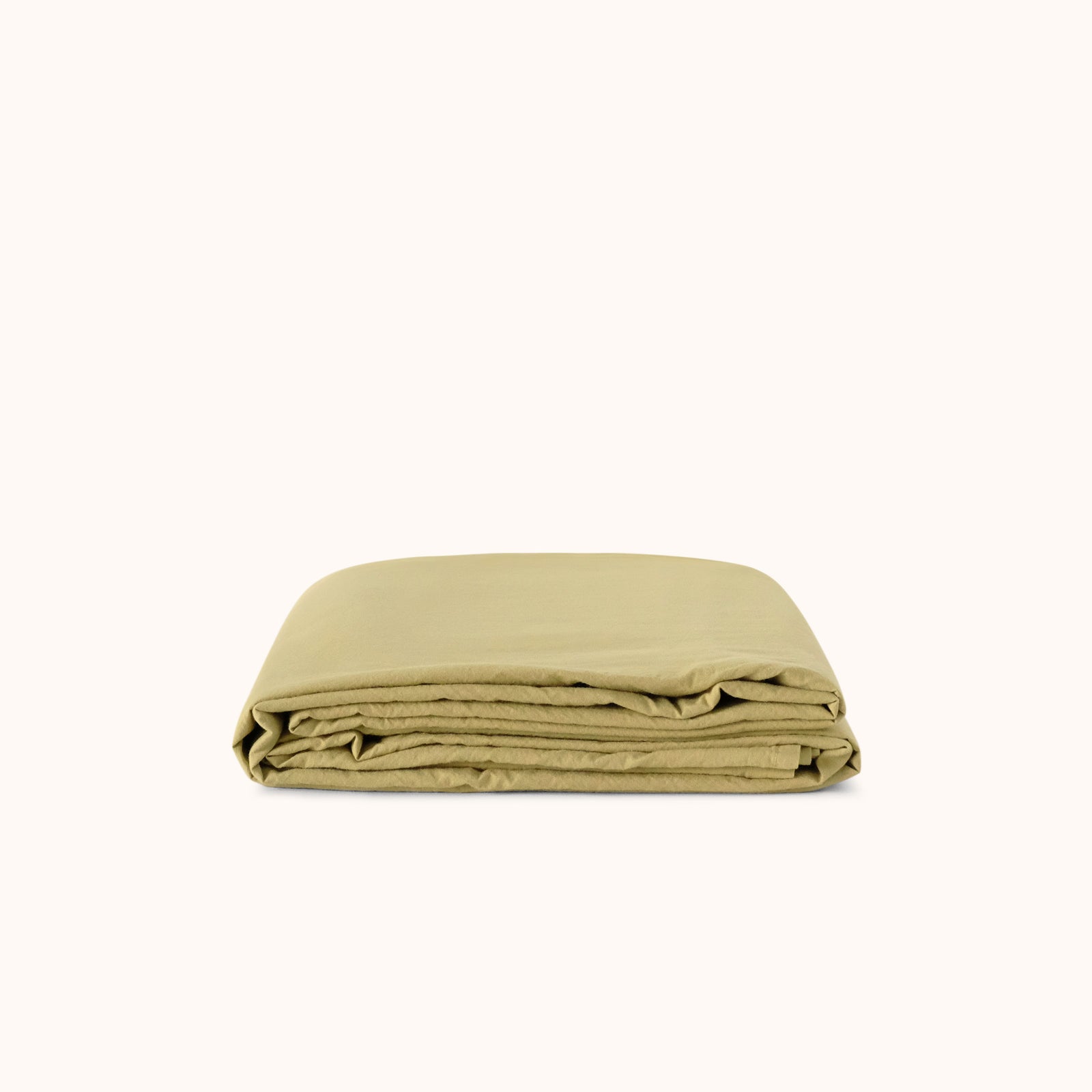 Folded green flat sheet on a white background