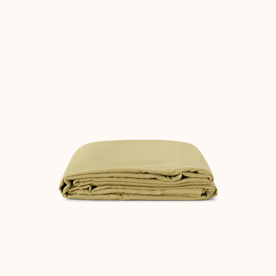 Folded green flat sheet on a white background