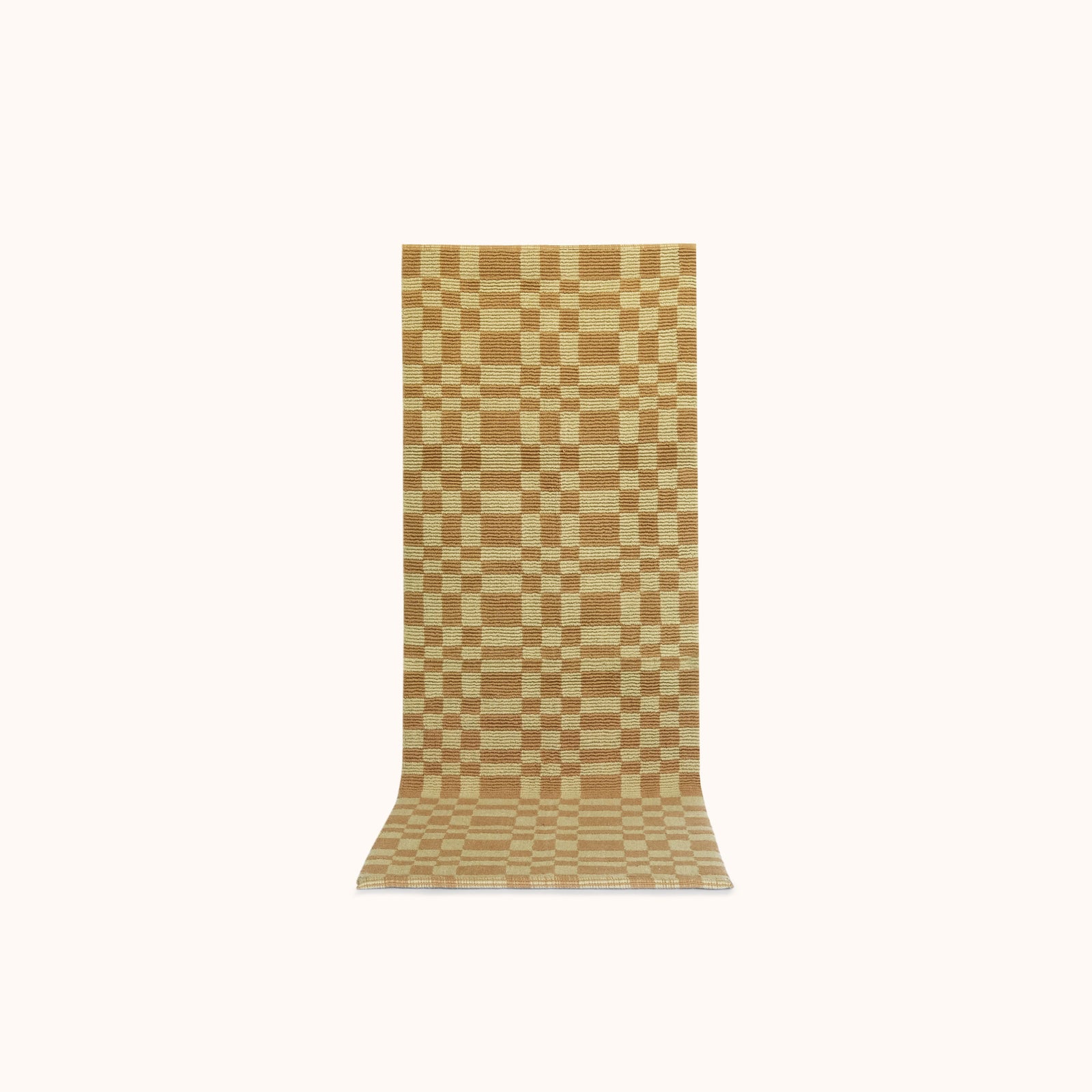 A long rectangular mat with a pale olive and light brown checkerboard pattern, displayed flat against a solid off-white background.