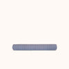 A long cylindrical bolster pillow with alternating blue and brown stripes