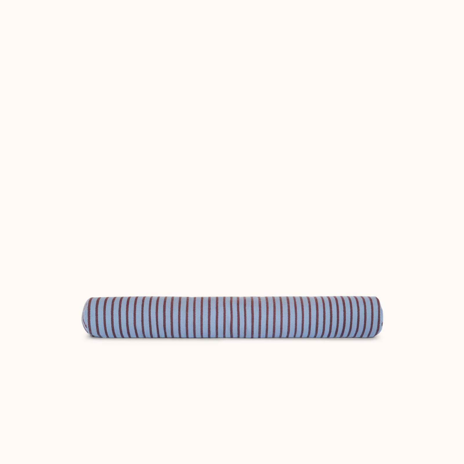 A long cylindrical bolster pillow with alternating blue and brown stripes