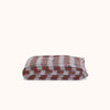 A folded checkered blanket with a pattern of red, brown, and blue stripes, displayed on a clean off-white background.
