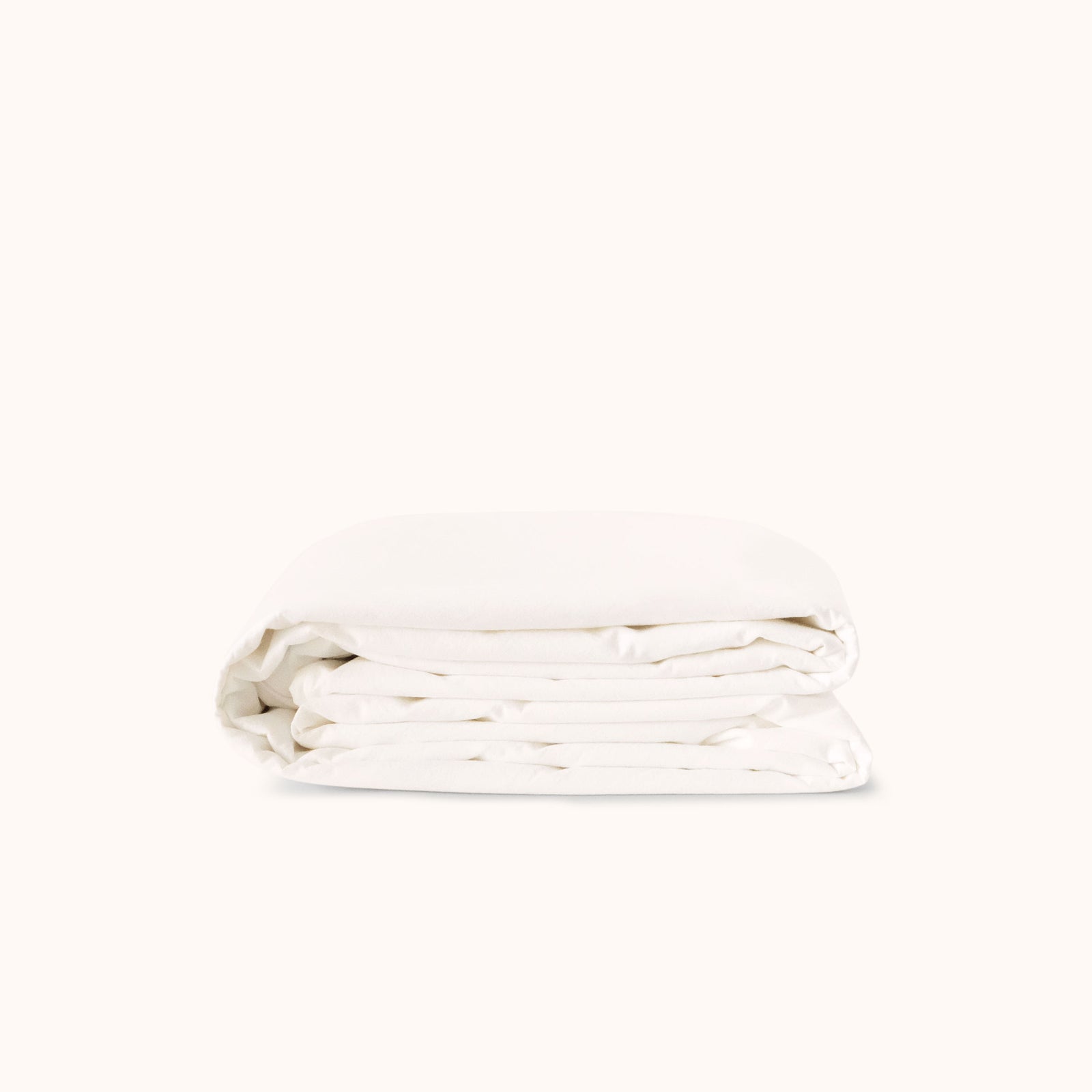 Folded white duvet cover on a white background