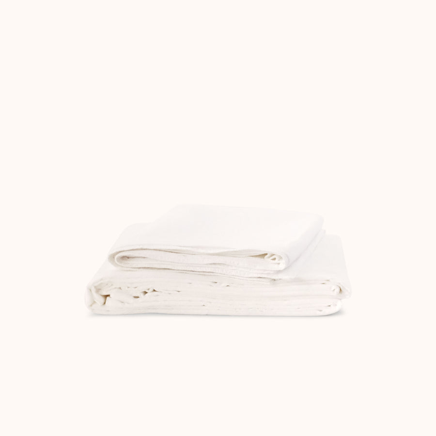 Folded white sheets on a white background