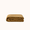 Folded brown duvet cover against a white background