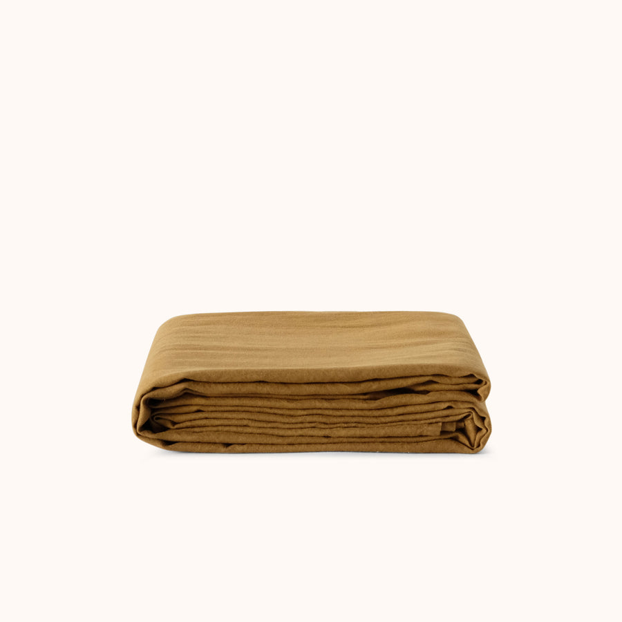 Folded brown flat sheet against a white background