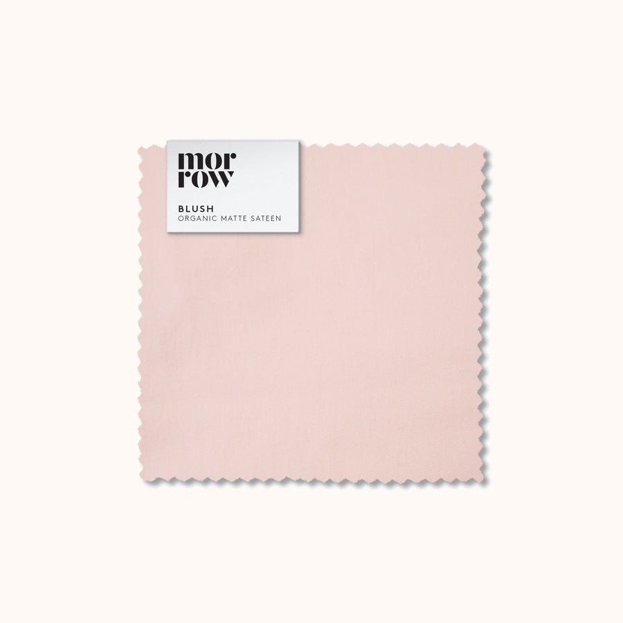 An organic matte sateen blush fabric swatch with a Morrow label